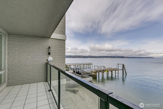 dock area featuring a balcony and a water view