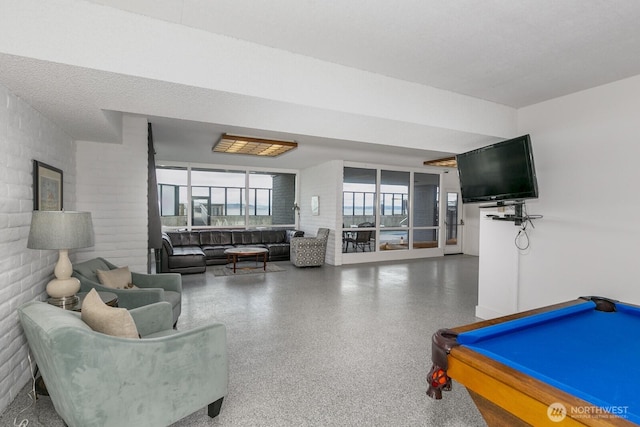 recreation room with pool table, a textured ceiling, and speckled floor