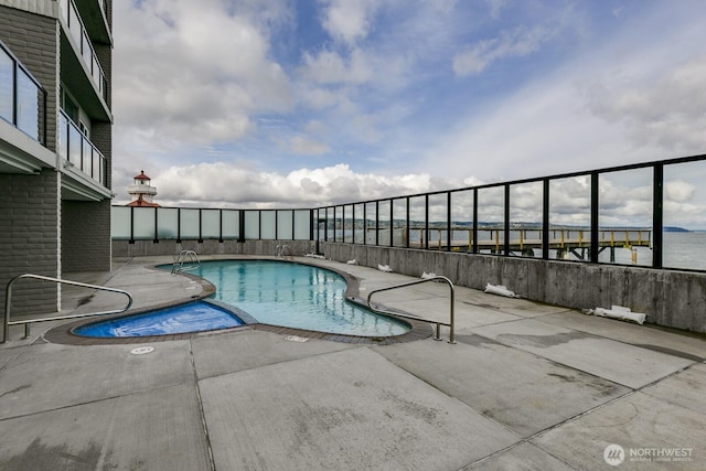 community pool with a patio area