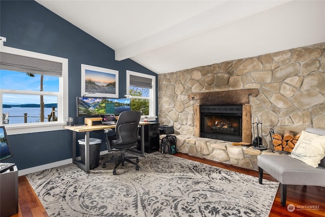 home office with wood-type flooring, vaulted ceiling with beams, and a wealth of natural light