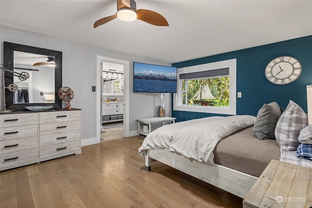 bedroom with connected bathroom, ceiling fan, and light hardwood / wood-style floors