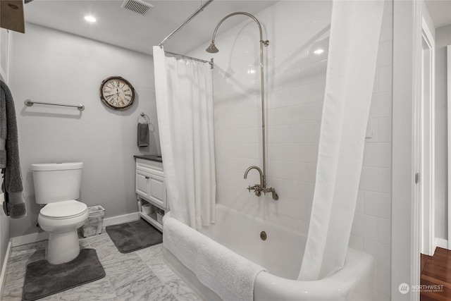 bathroom with toilet and shower / bath combo with shower curtain