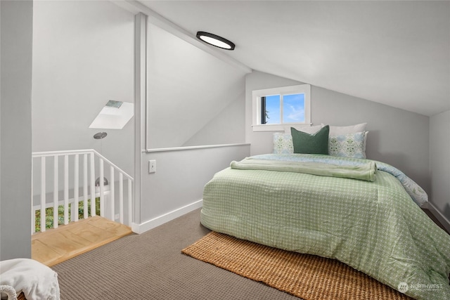 bedroom featuring carpet flooring and vaulted ceiling