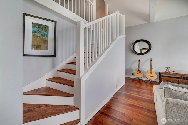 stairway featuring baseboards and wood finished floors