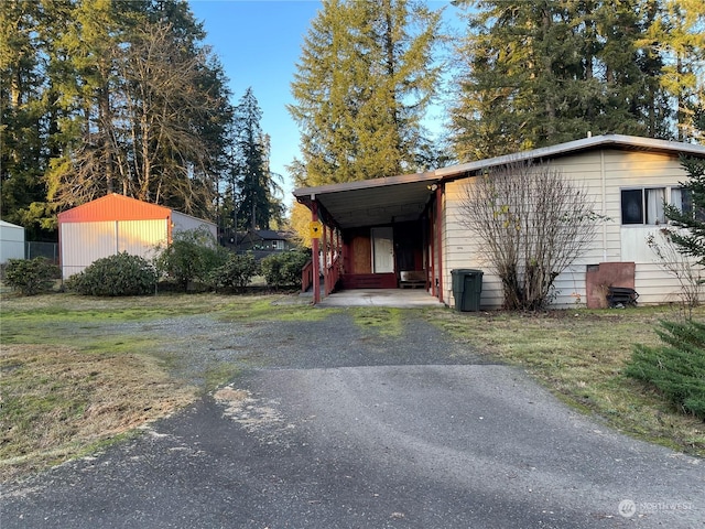 view of outbuilding featuring a carport and a lawn