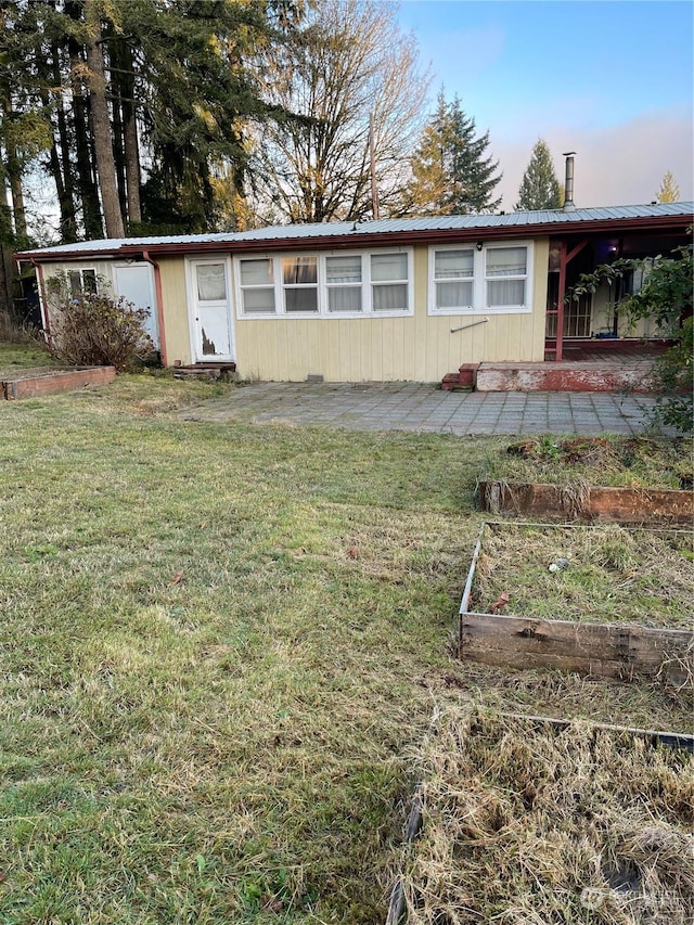 back of house featuring a yard and a patio area