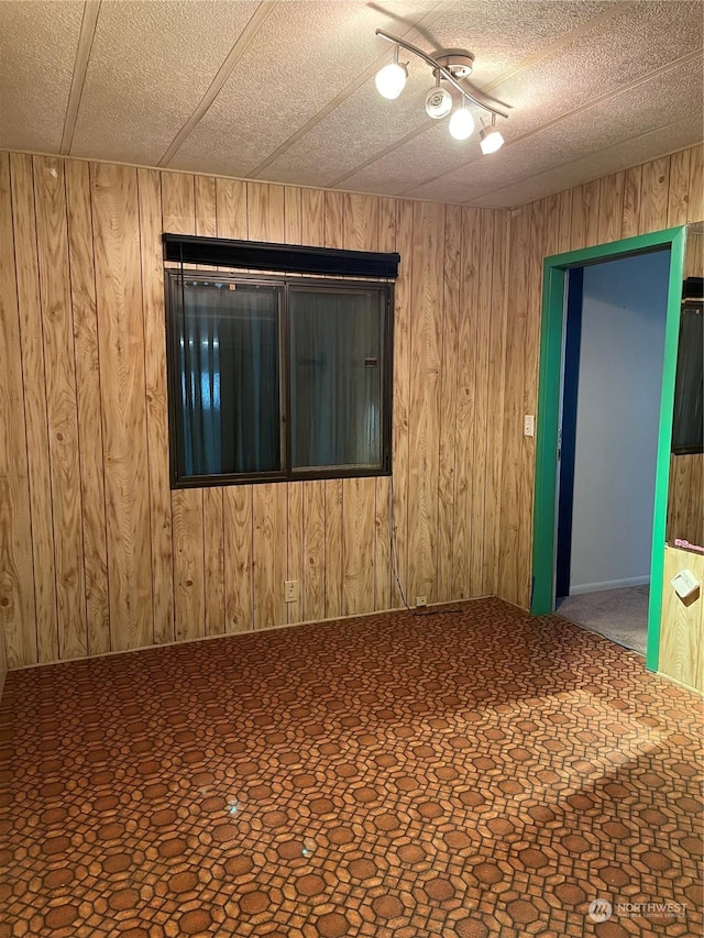 spare room with wooden walls