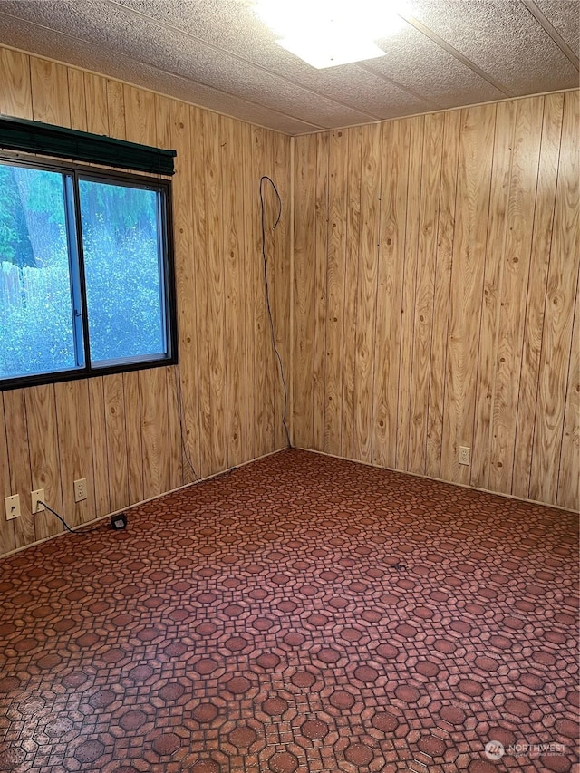 unfurnished room with wooden walls