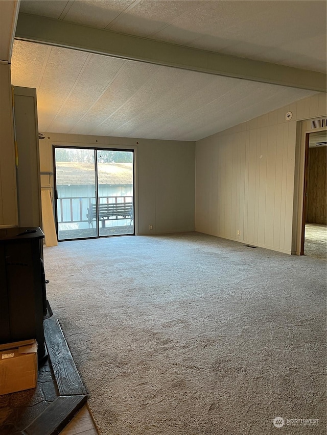 unfurnished living room featuring beam ceiling and light carpet