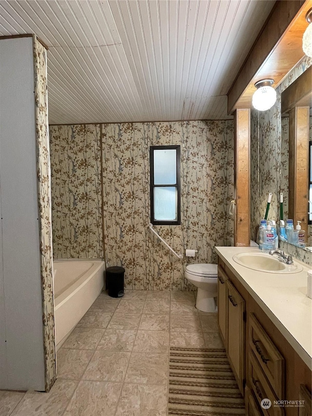 bathroom featuring a washtub, vanity, toilet, and wooden ceiling