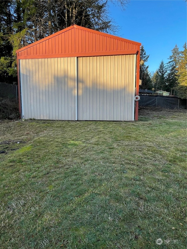 view of outbuilding with a yard