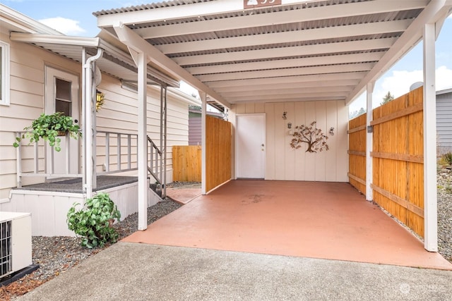 view of patio with central AC unit and a carport