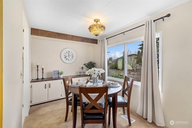 dining area featuring light colored carpet