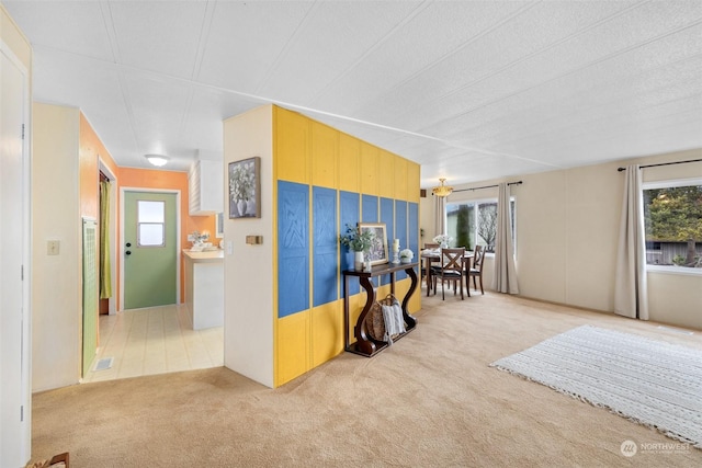 interior space featuring carpet floors, a textured ceiling, and a wealth of natural light