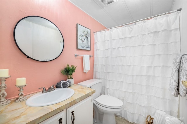 bathroom featuring vanity, curtained shower, and toilet