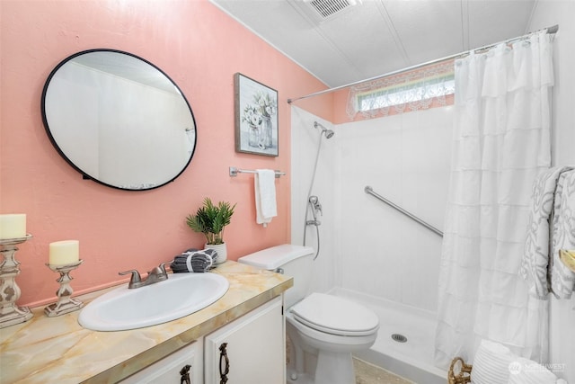 bathroom featuring vanity, toilet, and walk in shower