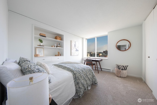 carpeted bedroom featuring a baseboard radiator