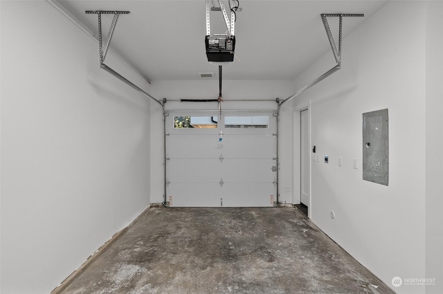 garage with electric panel and a garage door opener