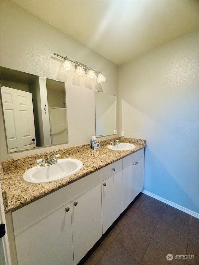 bathroom featuring tile patterned flooring and vanity