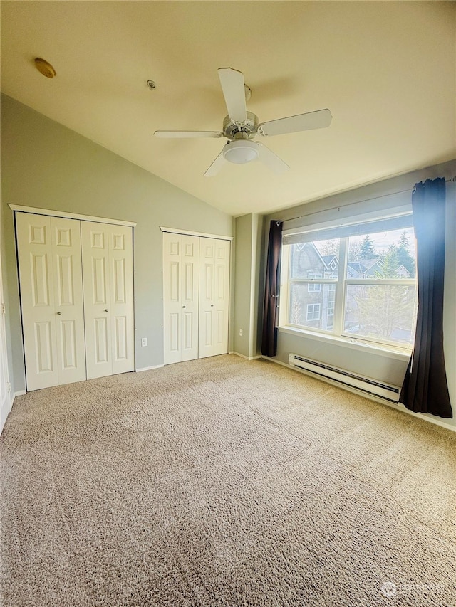 unfurnished bedroom featuring carpet, lofted ceiling, ceiling fan, and a baseboard heating unit