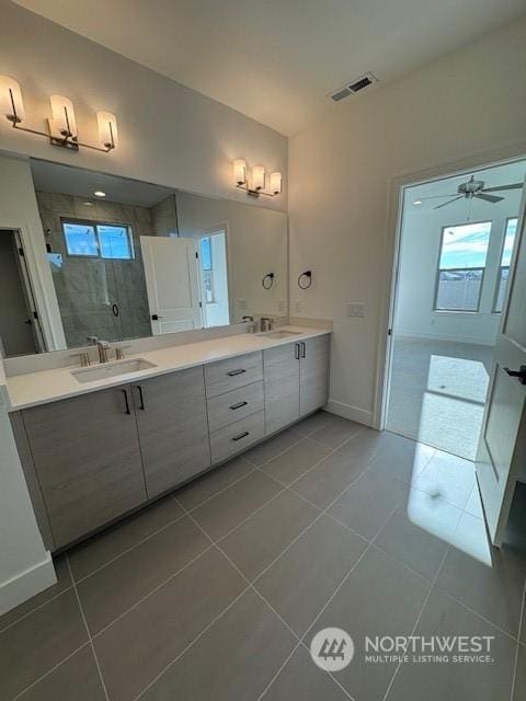 bathroom with tile patterned floors, a shower with shower door, and vanity