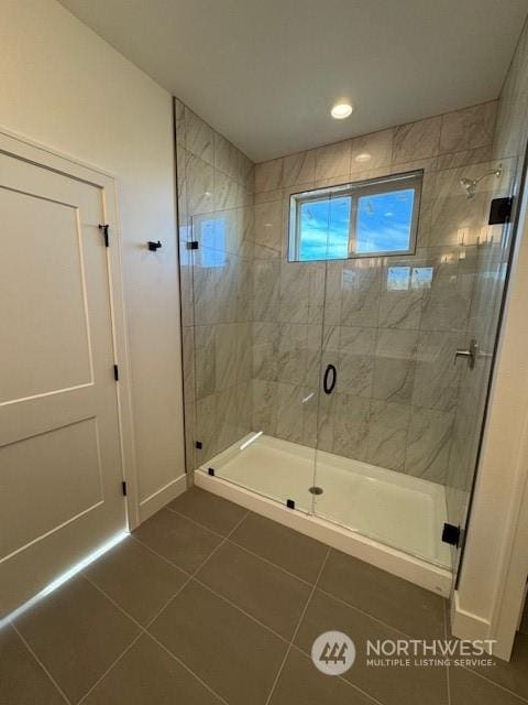 bathroom featuring tile patterned floors and a shower with door