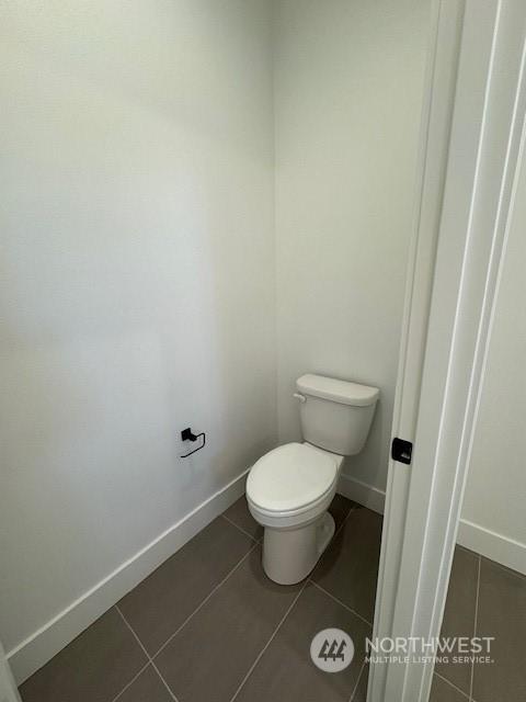 bathroom featuring tile patterned floors and toilet