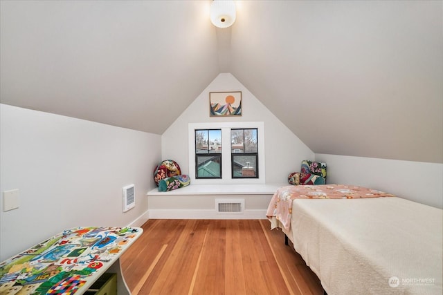bedroom with hardwood / wood-style flooring and vaulted ceiling