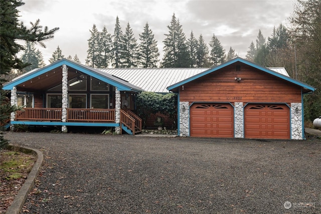 log-style house with covered porch