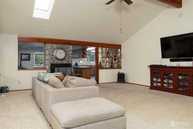 living room with high vaulted ceiling, ceiling fan, a fireplace, beam ceiling, and light colored carpet