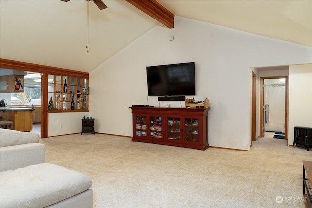 carpeted living room featuring ceiling fan, beam ceiling, and high vaulted ceiling