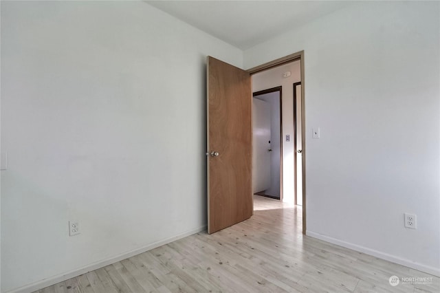 empty room with light hardwood / wood-style flooring