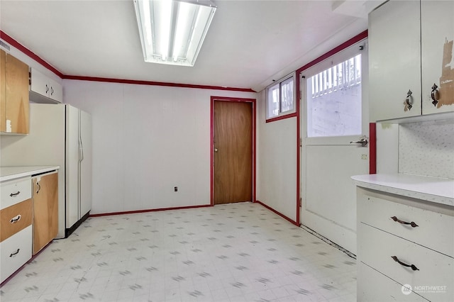 kitchen featuring dishwasher, white cabinetry, and ornamental molding