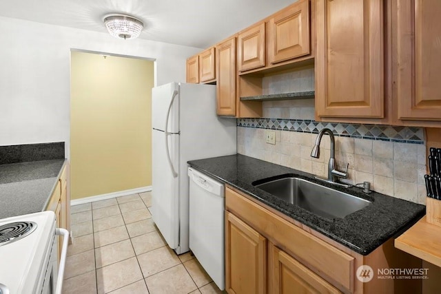 kitchen with sink, tasteful backsplash, dark stone counters, white appliances, and light tile patterned floors