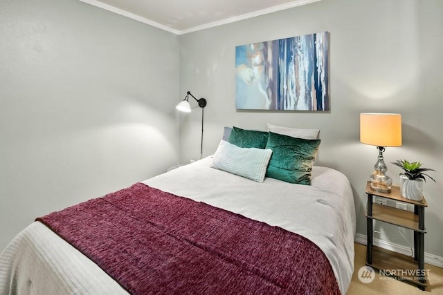 bedroom with hardwood / wood-style floors and ornamental molding