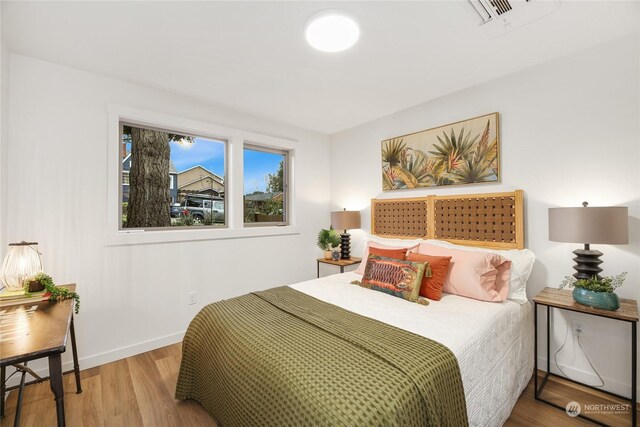 bedroom with wood-type flooring