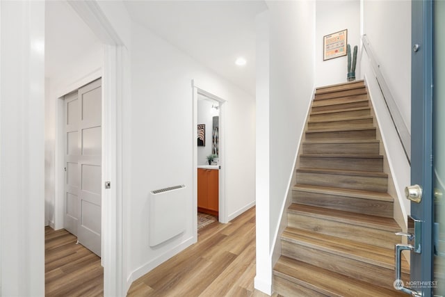 stairs featuring wood-type flooring