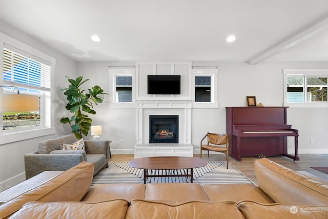 living room with light hardwood / wood-style flooring and beamed ceiling