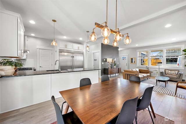 dining room with light hardwood / wood-style flooring and sink