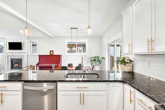 kitchen with white cabinetry, sink, and decorative light fixtures