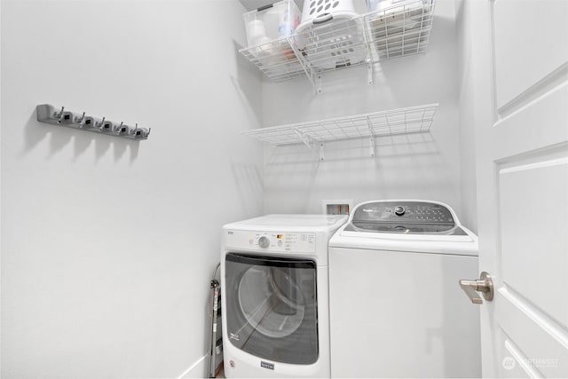 clothes washing area with separate washer and dryer