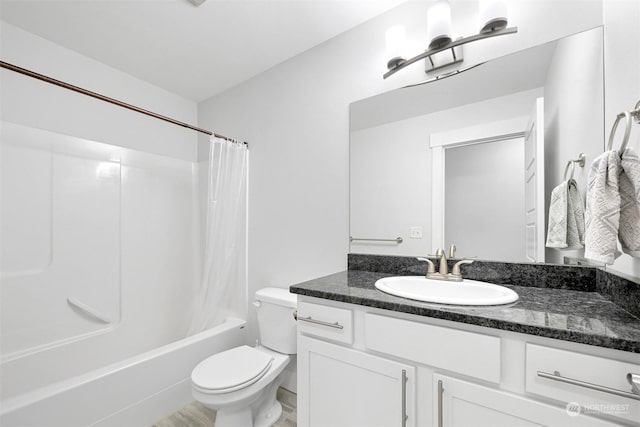 full bathroom with shower / bath combo, vanity, and toilet