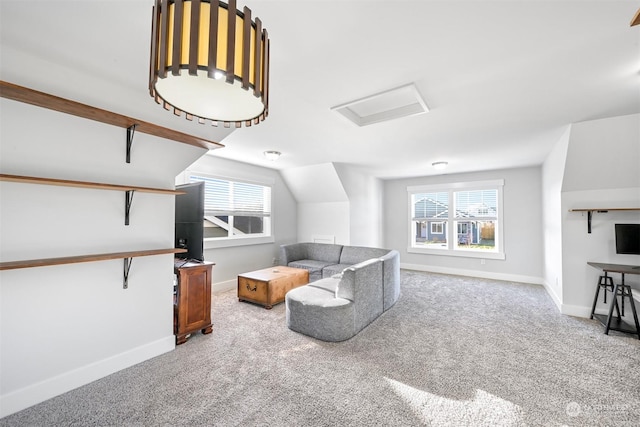 carpeted living room featuring plenty of natural light and lofted ceiling