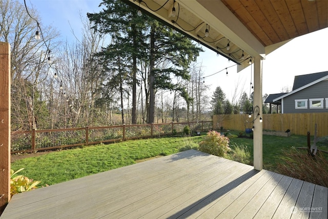 wooden deck featuring a lawn