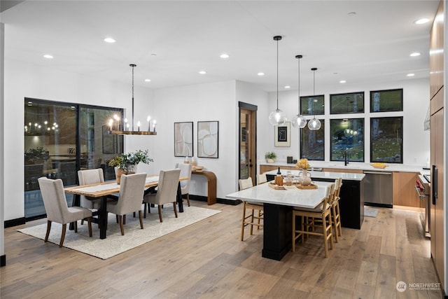 dining space featuring light hardwood / wood-style floors and sink