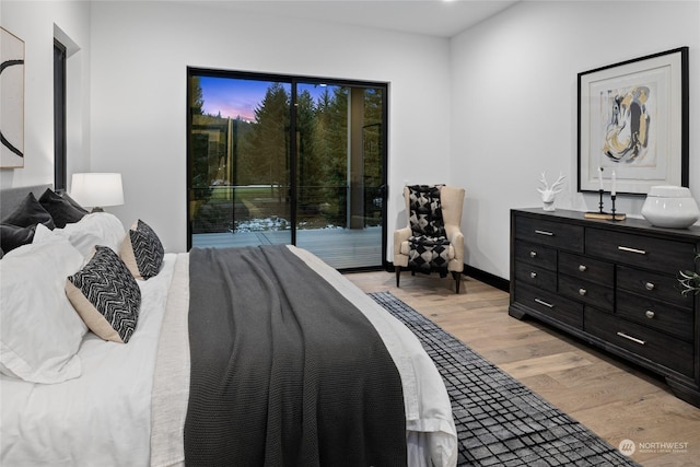 bedroom featuring light hardwood / wood-style floors and access to outside