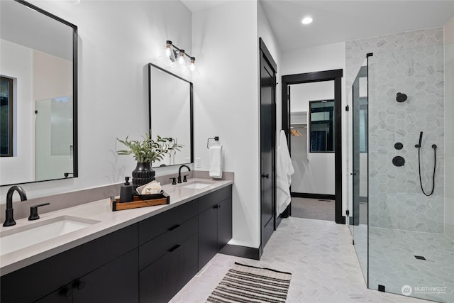 bathroom featuring a tile shower and vanity