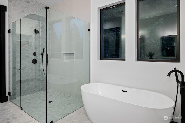 bathroom with tile patterned flooring and separate shower and tub