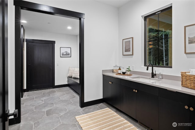 bathroom with tile patterned floors and vanity