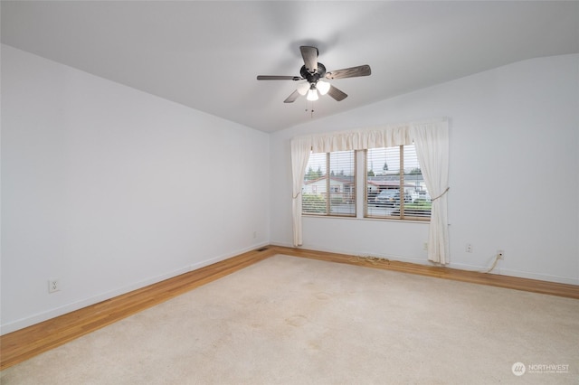 empty room with light hardwood / wood-style floors, ceiling fan, and lofted ceiling